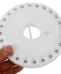 Hand holding LED Camping Lantern Round Waterproof Portable Tent Light for Hiking and Emergencies. Top view of white lamp.