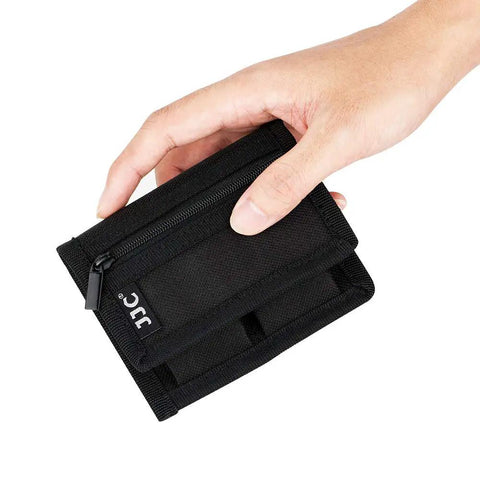 Hand holding Durable Camera Battery Pouch Case For 2 Batteries With Zipped Card Pocket, black polyester, compact size