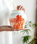 Top Shelf Slick Ceramic Tea Canister Set Featuring Sealed Lids For Loose Leaf Tea Coffee Beans Spices And Easy Pantry Organization Stylish Multi Jar Vessel For Home Use, hand-held ceramic jar with red and white design.