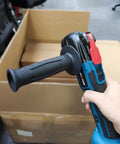 Cordless Battery Angle Grinder With Variable Speed And Low Vibration Ergonomic Handle held in hand for easy paint scraping.