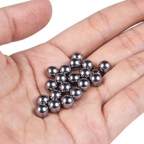 Hand holding 20 chrome steel bearing balls from the 630 Piece Assorted Chrome Steel Bearing Balls Built Damn Tough For Smooth Bicycle Repairs And Precision Machinery Garage Shop Essential Heavy Duty Corrosion Free Sizes.