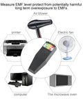 EMF Meter For Ghost Hunting With Instant EMF Response and LED Display surrounded by household electronics like printer and fan.