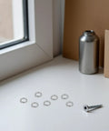Top Shelf Heavy Duty Stainless Steel Spring Lock Washers M6 300 Piece Non Slip Nut And Bolt Fasteners scattered near a silver screw.
