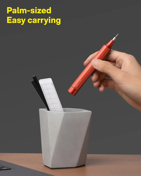 Slick 24-In-1 Mini Screwdriver Set with Eyeglass Repair Kit and Precision Bits for Tiny Screws Perfect Pocket Sidekick for Daily Chores and Road Trips in Sleek Cinnabar Red Finish held over a gray pot.