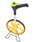 Digital Telescopic Measuring Wheel Featuring Glowing Lcd Screen With Auto Storage Modes For Dead Accurate Distance Tracking Sturdy Plastic Chassis Works Like A Dream Outside, showing bright LCD display and yellow wheel.