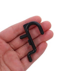 150 Pcs Plastic Pegboard Hooks For Tool Storage And Small Kitchen Supplies, Heavy Duty Repositionable Pegboard Hangers With Easy Assembly, Ideal For Retail Displays And Garage Organization, Studio Gear Black pegboard hook in hand