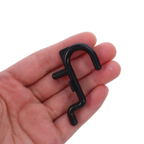 150 Pcs Plastic Pegboard Hooks For Tool Storage With Stable Holding Structure And Flexible Storage Layout Black Self Locking Peg Hooks For Kitchen And Workshop Organization Super Handy For Quick Access black plastic pegboard hook held in hand