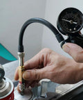 Close-up of NICECNC nitrogen needle kit with needle head replacement connected to a shock absorber; gauge and hose visible.