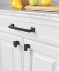 Matte Black Cabinet Pulls 10 Pack 5 Inch Center To Center Hardware installed on a white kitchen cabinet drawer.