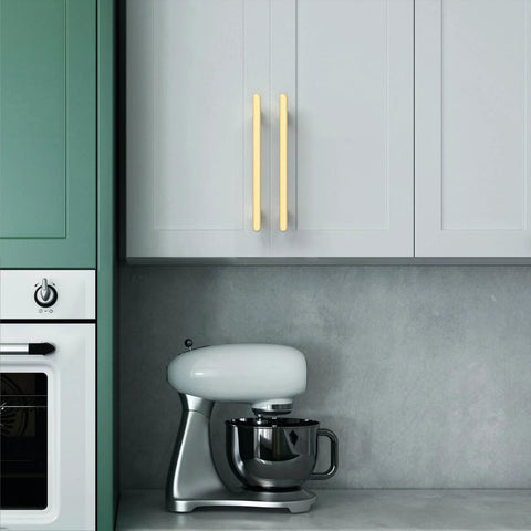 Modern kitchen with 10 Pack 5 Inch Brushed Gold Cabinet Handles For Kitchen Cabinets And Drawers installed on white cupboard doors.