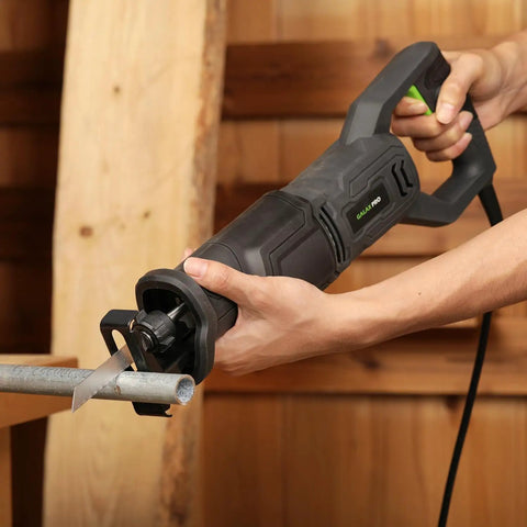 Close-up of Heavy Duty Corded Reciprocating Saw 120V With 6.0 Amp Motor And 2800 RPM, cutting metal pipe effortlessly.