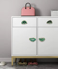 Four Pack Green Agate Slice Cabinet Knobs And Drawer Pulls Featuring Solid Brass Hardware on modern white dresser with pink bag.