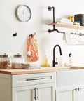 Top Shelf Pro Modern Oil Rubbed Bronze Cabinet And Drawer Pulls Delivering A Fresh Vibe And Solid Grip Perfect For Your Home Decor Update Project And Fast Installation in a kitchen setting with a clock and shelf.