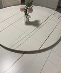Built Tough 23 Inch Marble Lazy Susan With Butter Smooth 360 Degree Swivel Action And Rock Solid Nonslip Base on a dining table with flowers.