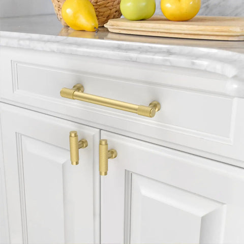 Premium 10 Pack Brushed Gold Knurled Cabinet Knobs on white kitchen cabinets with fruit in background.