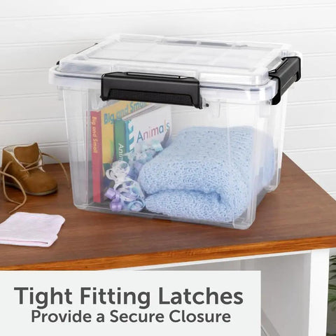 3 Pack 19 Quart Waterproof Storage Bins IP68 Clear Plastic Totes With Gasket Sealed Lids on a table with books and blankets inside.