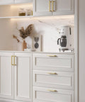 Modern Square Brushed Brass Drawer Pulls With Five Inch Hole Center And Durable Steel Body Kitchen Cabinet Handles on white cabinets.