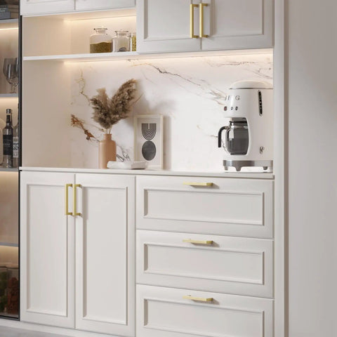 Modern Square Brushed Brass Drawer Pulls With Five Inch Hole Center And Durable Steel Body Kitchen Cabinet Handles on white cabinets.