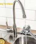 Rechargeable Cordless Immersion Blender With Sweet Egg Whisk Attachment under running water in a sink for easy cleaning.