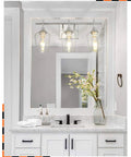 Three Light Vanity Light Fixture Over Mirror in Brushed Nickel With Clear Glass Wine Glass Shades in modern bathroom