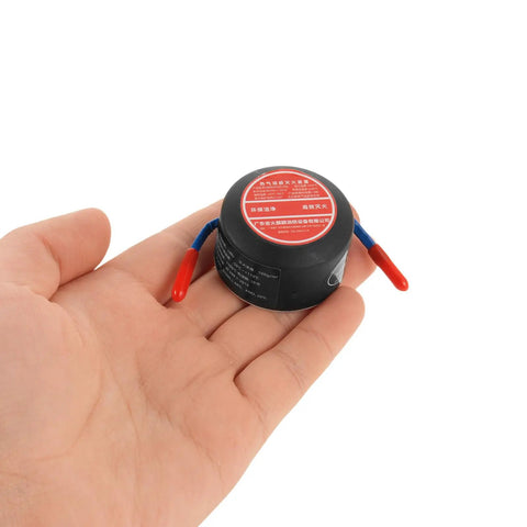 Automatic Aerosol Fire Extinguisher With Slick Adhesive Mount For Cars Garages And Shops Stops Heat Smooth, held in hand.