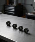 Tough As Nails Nylon Pulley Wheels For Door And Window Track 4 Pack Silky Smooth Replacement Rollers pre-greased nylon rollers on a table.