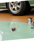 Low Key No Stress Automatic Aerosol Fire Extinguisher 2 Pack with Heavy Duty Back Adhesive on garage floor near vehicle.
