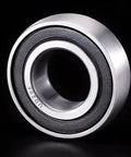 Heavy Duty 20X47X14mm Insert Ball Bearing With Spherical Outer Ring For Industrial Equipment viewed from the side, showcasing its sleek design.