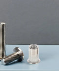 Stainless Steel Pro Grade Rivet Nut Kit 70 Pack Flat Head Threaded Inserts For Machinery, Furniture And Electronics displayed on table
