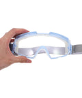 Heavy Duty Blue Safety Goggles With Anti Fog Ventilation And Side Shields being held, showing clear lenses and elastic strap.