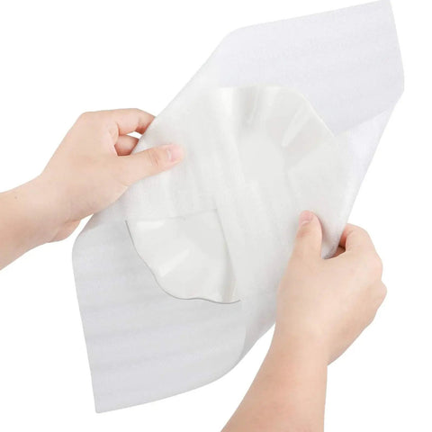 Hands holding a white Hella Durable White Epe Pearl Cotton Pouch, showcasing its soft padding for fragile items.
