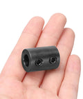 Rigid Shaft Coupling Three Eighths Inch Bore Three Quarters Inch Outer Diameter One Inch Long Steel Black Oxide held in hand