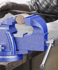 Heavy Duty 5 Inch Bench Vise With 360 Degree Swivel Locking Base Desktop Clamp in use on a workbench with metal file