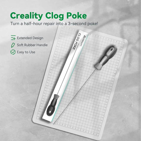 Creality Clog Poke tool on a grid cutting mat, featuring a soft rubber grip for 1.75mm extruders, helps clear clogs easily.