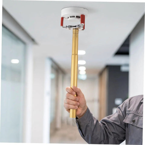 Smoke Sensor Removal Tool With Claw Head Attachment For Ceilings in use, showcasing aluminum alloy frame and grip, safely pulling a smoke detector.