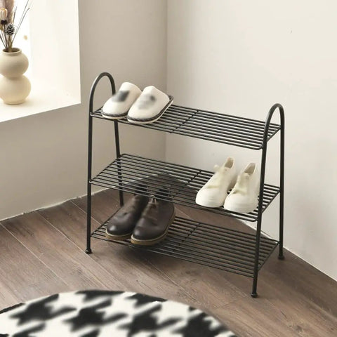 Heavy Duty Wrought Iron Shoe Rack Three Tier Floor Organizer Holds Up To A Dozen Pairs Of Your Favorite Kicks with white and brown shoes.