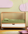 4 Piece Vintage Brass Finish Swivel Casters Heavy Duty 2 Inch Universal Furniture Wheels on a stylish infant crib with green bedding.
