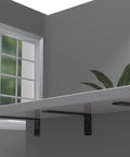 Rock Solid Heavy Duty Shelf Brackets Matte Black Floating L Brackets For Wall Mount Countertops 4 Pack supporting a countertop.