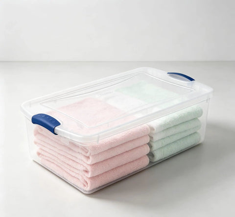 Heavy Duty 32 Quart Medium Clear Plastic Latching Storage Bin With Snap Tight Locking Lid Spill Resistant Container holding neatly folded towels.