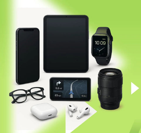 Assortment of electronics including tablet, phone, smartwatch, GPS, camera lens, glasses, and earbuds on green background.