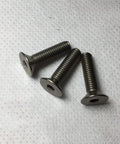 Three Kickass Grade 2 Titanium Countersunk Flat Head Screws With Hex Socket Allen Drive M8 By 1.25 X 40 Millimeter on a white surface.