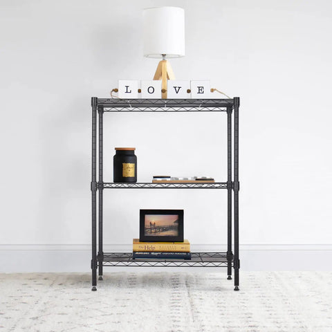 Tough As Nails Three Tier Wire Shelving Rack With Adjustable Steel Bars For Garage Home Closet Organization No Fuss Assembly Fits 23 By 13 By 30 Inches Holds Up To Four Fifty Pounds Black displaying decorative items and books.