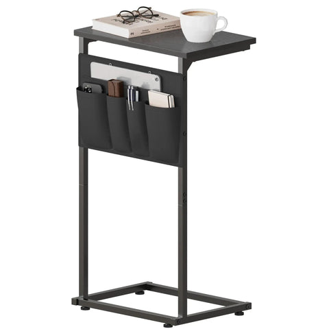 C Shaped End Table With Sliding Tray Under Sofa 28 Inch High Side Table With Storage Bag Black in living room setting with books and coffee