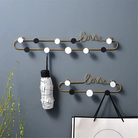 Top Tier Wrought Iron Letter Wall Hooks Slick Gold Finish Heavy Duty Coat And Key Hangers Modern Entryway Decor with black and white dots.