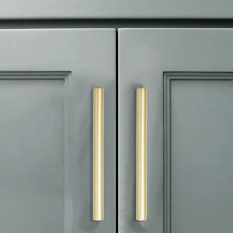 Close-up of Heavy Hitter Brushed Gold Cabinet Pulls 10 Pack Solid Drawer Hardware 6 Inch Hole Center on gray cabinet doors.