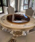 Black Tempered Glass Lazy Susan Turntable Serving Tray, 28 Inch Round Base with Heavy Duty Swivel atop an elegant dining table.
