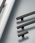 Top Tier Matte Black Cabinet Pulls And Drawer Handles 10 Pack Solid Metal Kitchen Hardware on light surface, showing curved design.