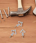 50 Pack Drywall Butterfly Anchors Kit With Heavy Duty Steel And Plastic on wood surface next to tools