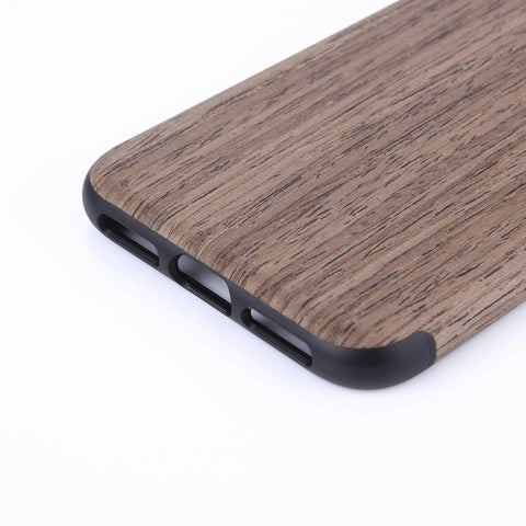Wooden phone case close-up with dark accents and sleek finish, showcasing texture and durability