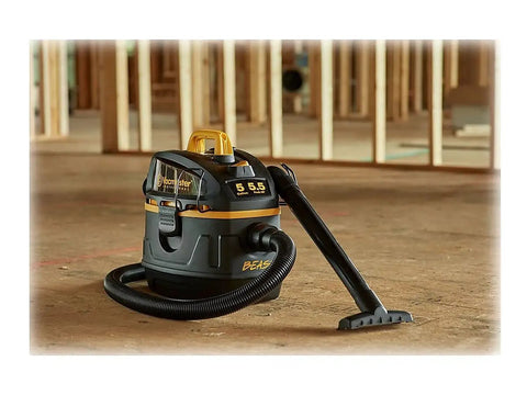 Beast Series 5 Gallon Wet Dry Vacuum With 5.5 HP Motor, 1-7/8 Inch Hose on a construction site floor, black, heavy-duty design
